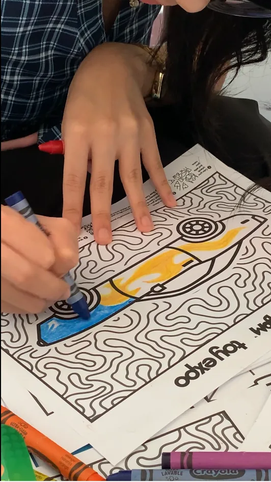 Visitor coloring a Toy Kingdom artwork
