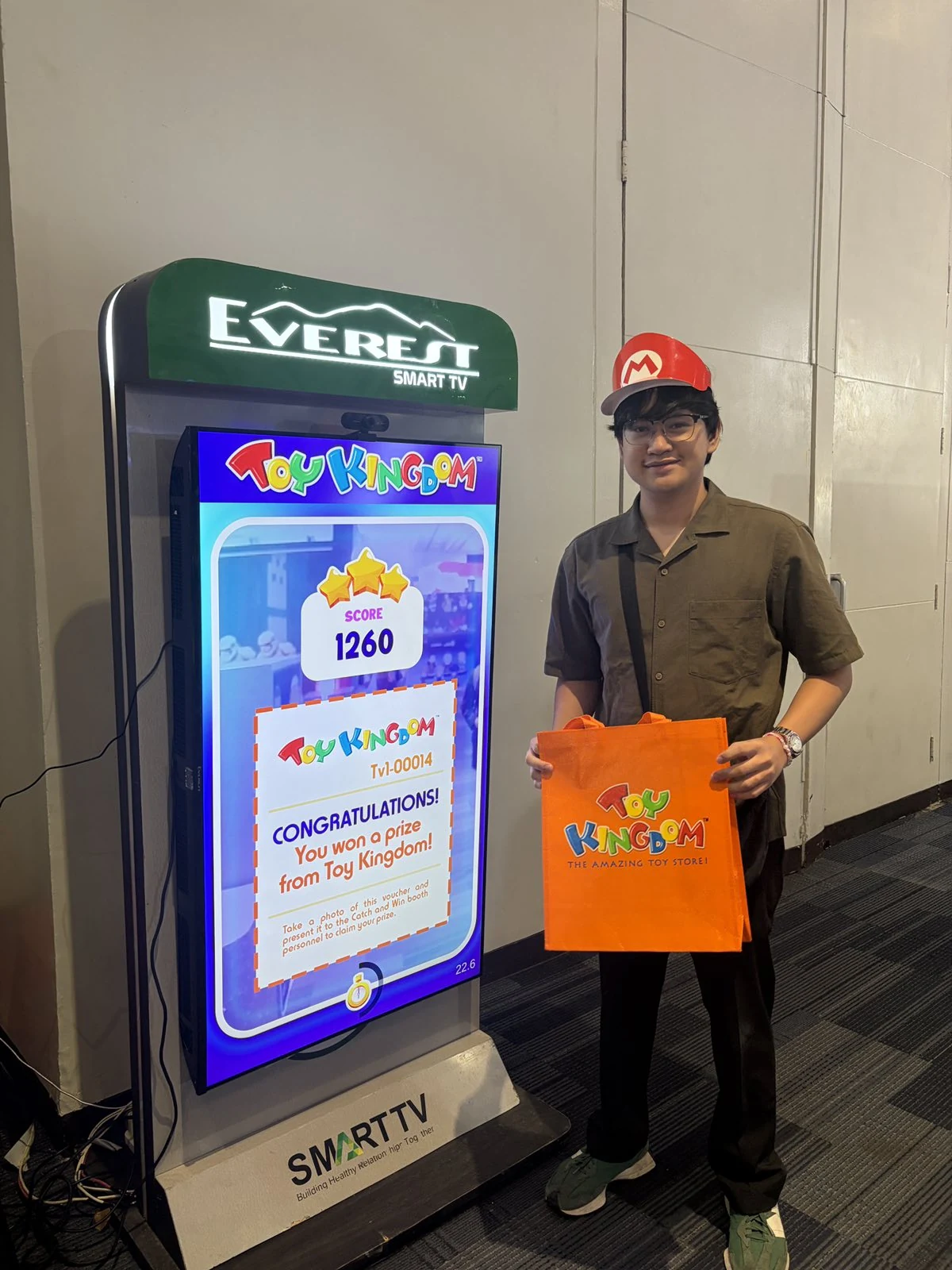 Catch and Win participant holding a Toy Kingdom prize bag