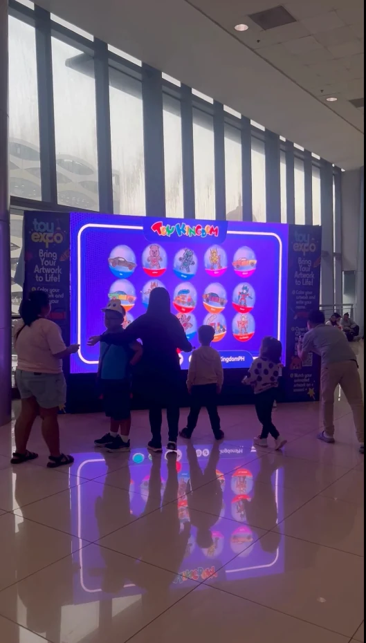 Visitors in front of the Toy Kingdom LED wall installation